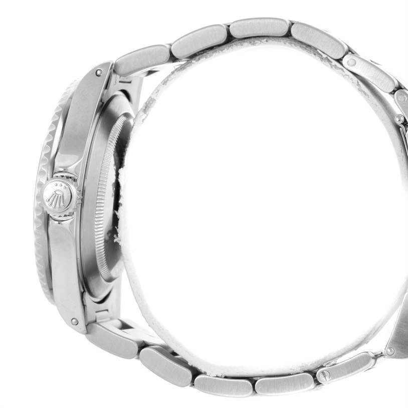 This side view of the Rolex Submariner 16610 Men
s Stainless Steel Black Dial 16610 Men
s Stainless Steel Black Dial watch shows the crown, case, and bracelet with a focus on its links.