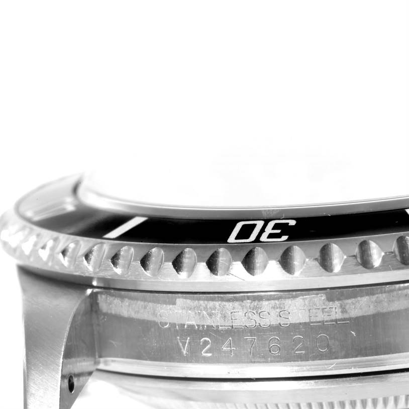 The image shows a side view of the Rolex Submariner 16610 Men
s Stainless Steel Black Dial 16610 Men
s Stainless Steel Black Dial watch, focusing on the stainless steel case and bezel with the etched model details.