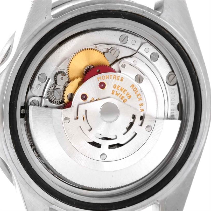 The image shows the back view of the Rolex Submariner 16610 Men
s Stainless Steel Black Dial 16610 Men
s Stainless Steel Black Dial, highlighting its movement and internal gears.