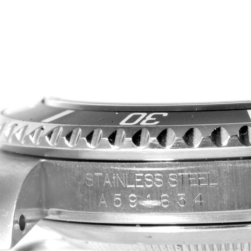 The image shows a side view close-up of the stainless steel bezel and part of the case of a Rolex Submariner 16610 Men
s Stainless Steel Black Dial 16610 Men
s Stainless Steel Black Dial watch.