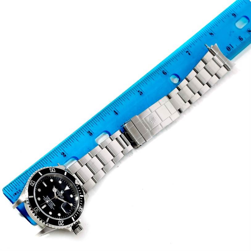 The Rolex Submariner 16610 Men
s Stainless Steel Black Dial 16610 Men
s Stainless Steel Black Dial watch is shown from above, featuring the face, bezel, and full metal bracelet with a clasp.