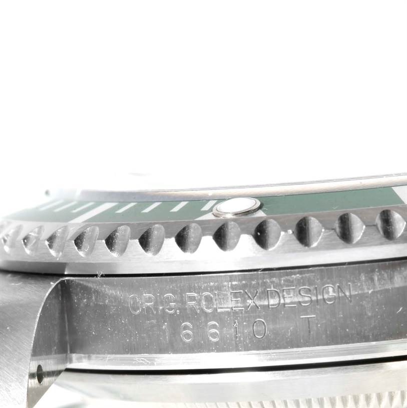 The image shows a close-up side view of the bezel and case of a Rolex Submariner 16610LV Men
s Stainless Steel Black Dial 16610LV Men
s Stainless Steel Black Dial watch, with visible inscription and model number.