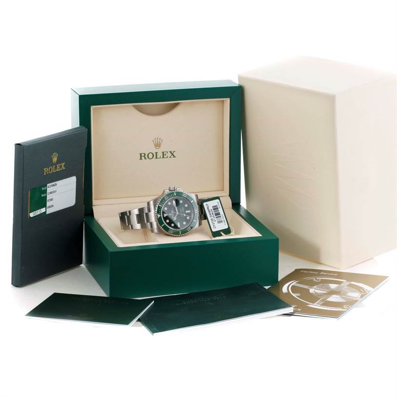 The image shows a Rolex Submariner 116610LV Men's Stainless Steel Green Dial 116610LV Men's Stainless Steel Green Dial watch in its open box, accompanied by booklets and tags, viewed from a front angle.