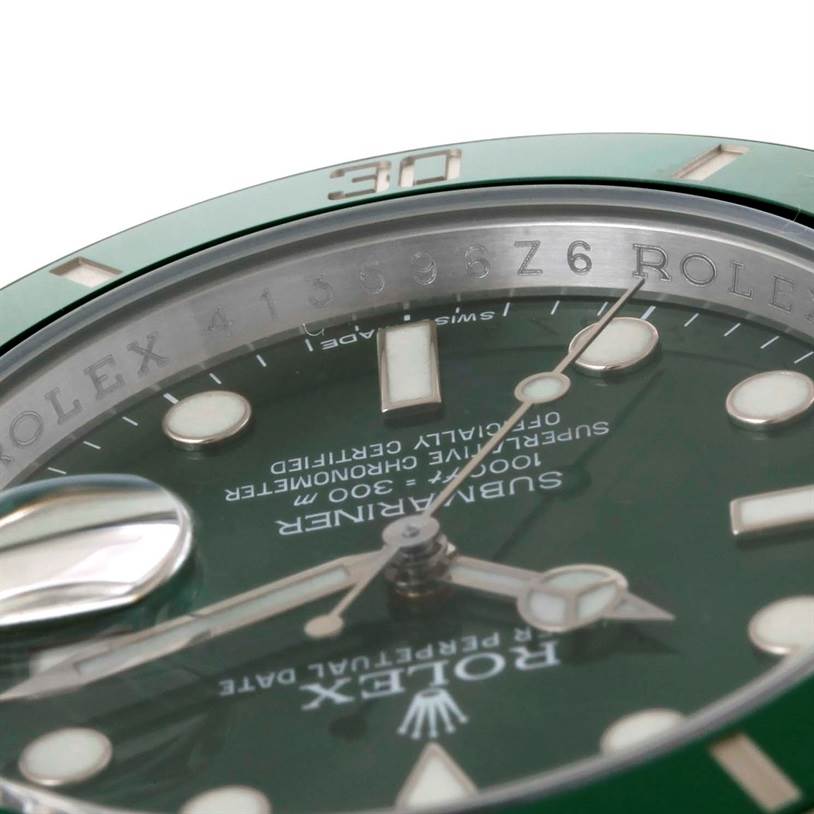 This is a close-up angled view of the dial, bezel, and inner perimeter with text of a Rolex Submariner 116610LV Men's Stainless Steel Green Dial 116610LV Men's Stainless Steel Green Dial watch.