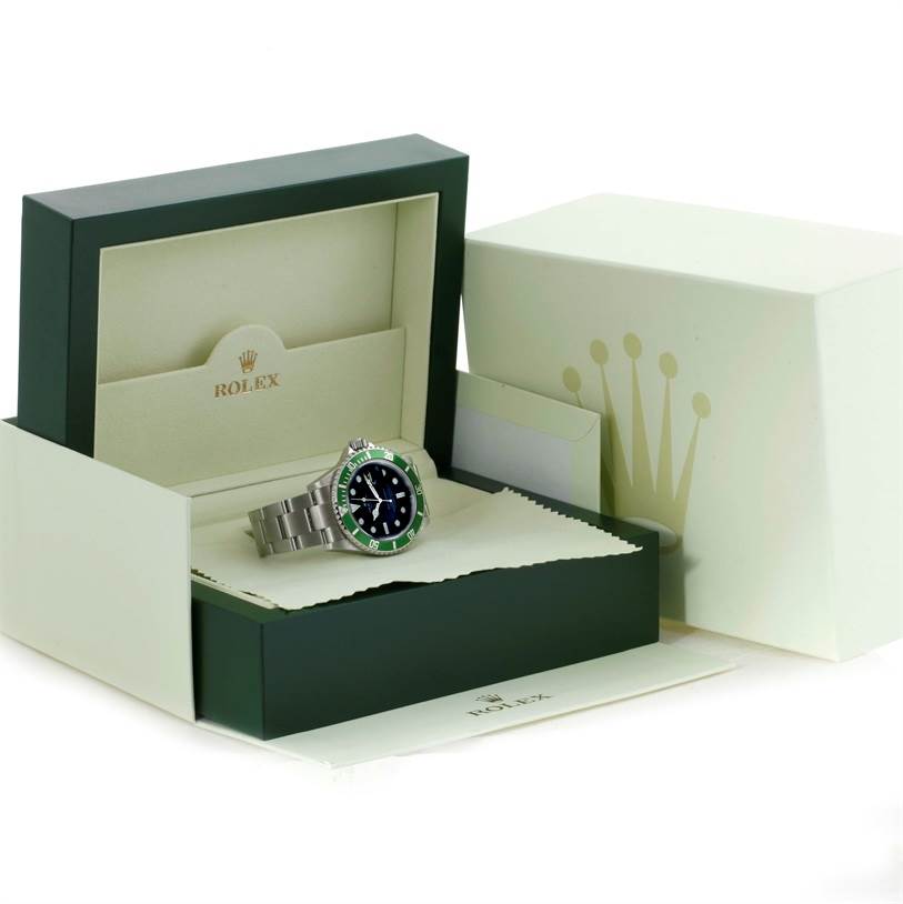 The image shows a Rolex Submariner 16610LV Men
s Stainless Steel Black Dial 16610LV Men
s Stainless Steel Black Dial watch in a partially open box, displaying the case and bracelet, along with packaging and accessories.