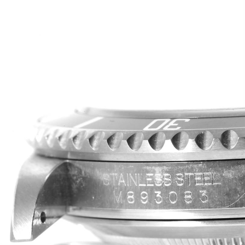 This image shows a close-up side view of a Rolex Submariner 16610 Men
s Stainless Steel Black Dial 16610 Men
s Stainless Steel Black Dial, highlighting the engraved "STAINLESS STEEL M893083" and the watch bezel.