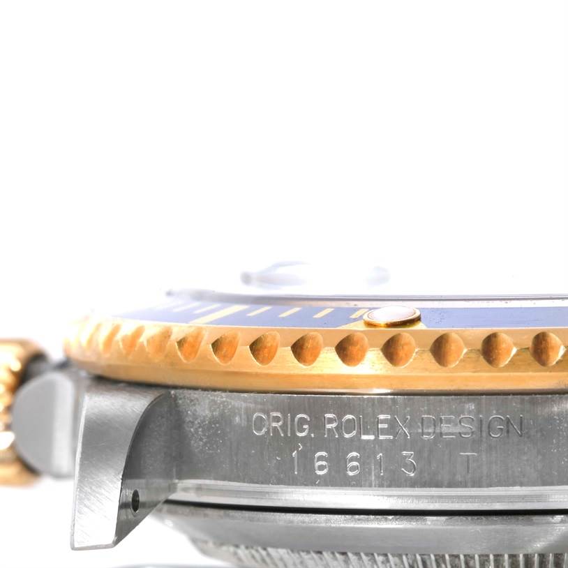 This image shows a close-up side view of the case and bezel of a Rolex Submariner 16613 Men's Steel and Gold (two tone) Blue Dial 16613 Men's Steel and Gold (two tone) Blue Dial watch, with model number 16613 engraved.