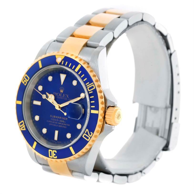 The image shows a Rolex Submariner 16613 Men's Steel and Gold (two tone) Blue Dial 16613 Men's Steel and Gold (two tone) Blue Dial watch from a slight front-right angle, highlighting its blue and gold bezel, crown, and bracelet.