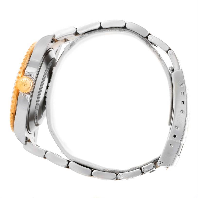 This image shows a side view of the Rolex Submariner 16613 Men's Steel and Gold (two tone) Blue Dial 16613 Men's Steel and Gold (two tone) Blue Dial, highlighting the crown and bracelet.