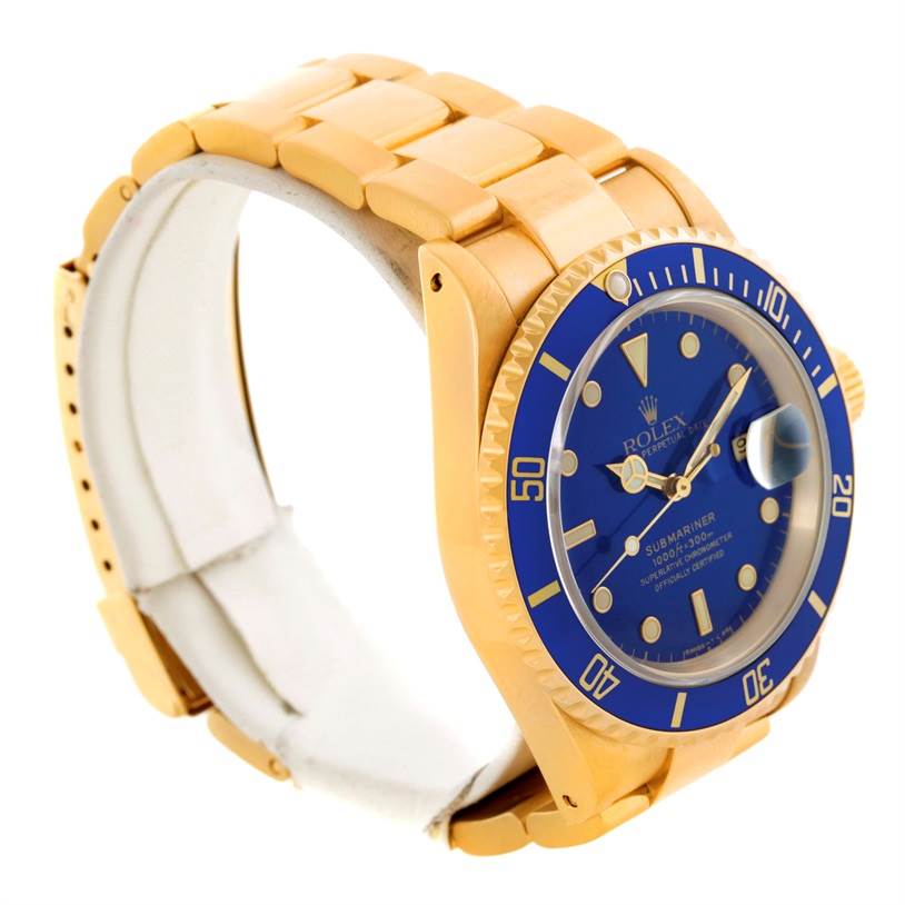 The Rolex Submariner 16618 Men's Yellow Gold Blue Dial 16618 Men's Yellow Gold Blue Dial watch is shown from a side angle, highlighting its gold bracelet, blue bezel, and blue dial.