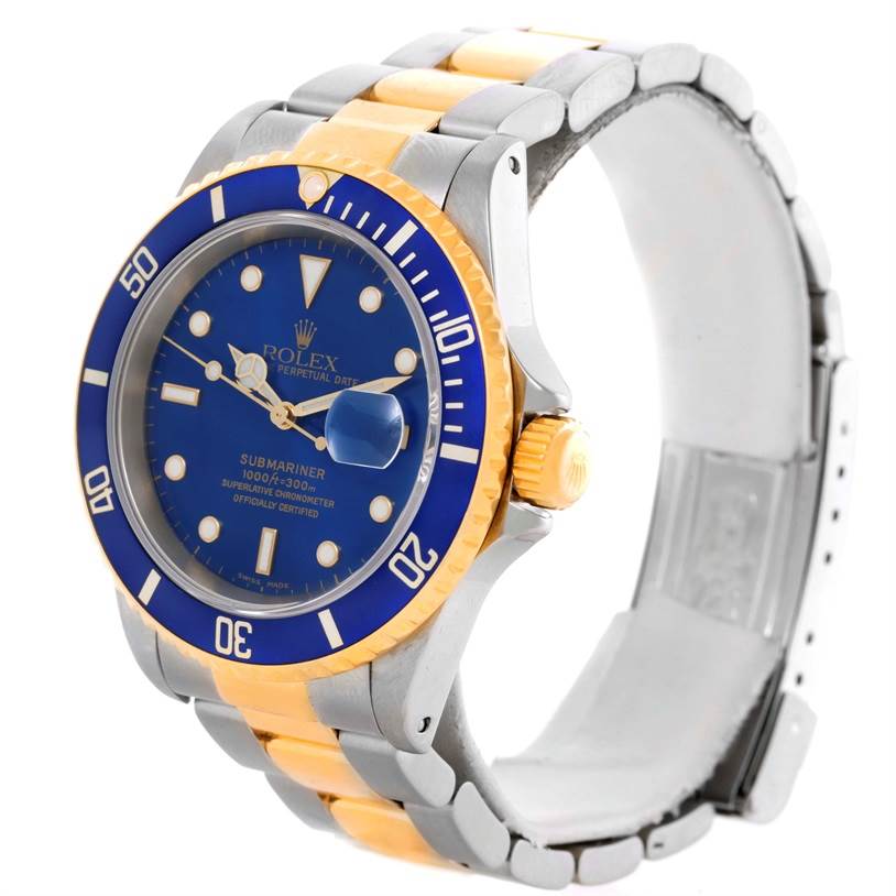 The image shows a Rolex Submariner 16613 Men
s Steel and Gold (two tone) Blue Dial 16613 Men
s Steel and Gold (two tone) Blue Dial watch at a slight left side angle, highlighting its blue dial, blue bezel, and two-tone bracelet.