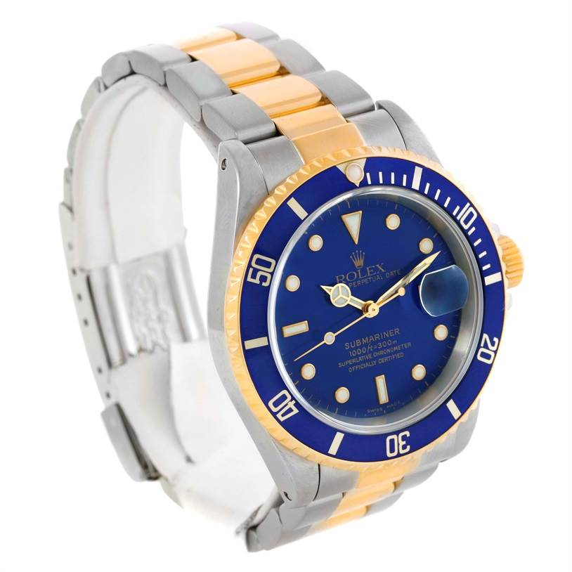 The image shows a Rolex Submariner 16613 Men
s Steel and Gold (two tone) Blue Dial 16613 Men
s Steel and Gold (two tone) Blue Dial watch at a three-quarter angle, displaying its blue dial, bezel, and two-tone bracelet.