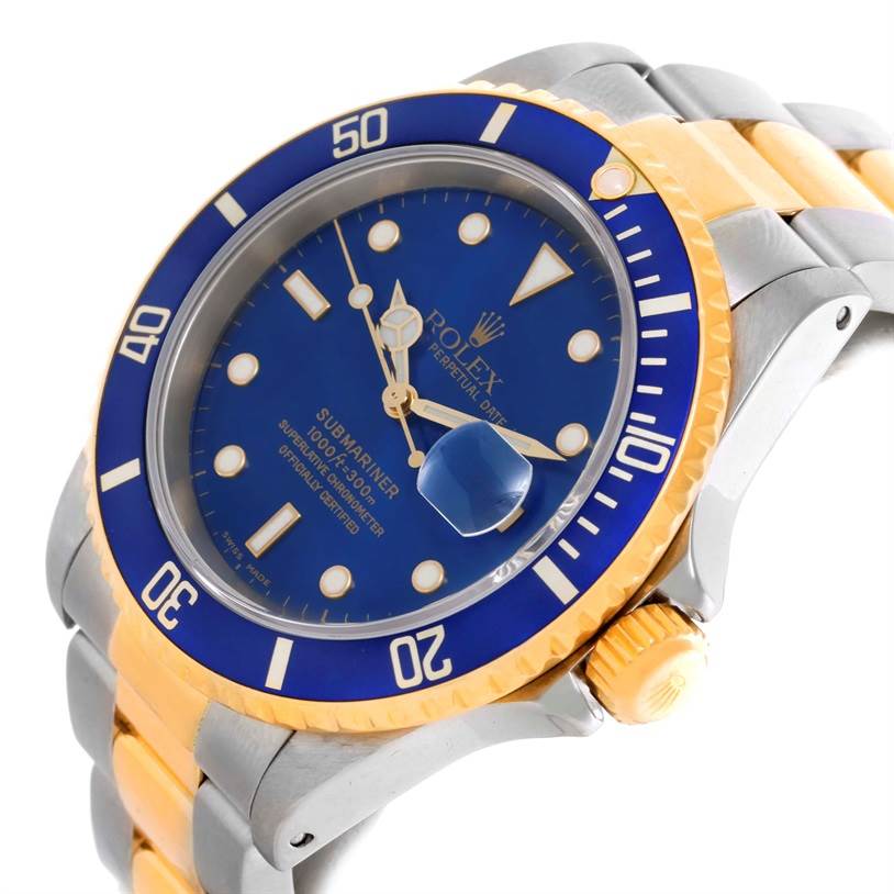 The image shows a side angle of a Rolex Submariner 16613 Men
s Steel and Gold (two tone) Blue Dial 16613 Men
s Steel and Gold (two tone) Blue Dial watch, focusing on its blue dial, bezel, and two-tone bracelet.