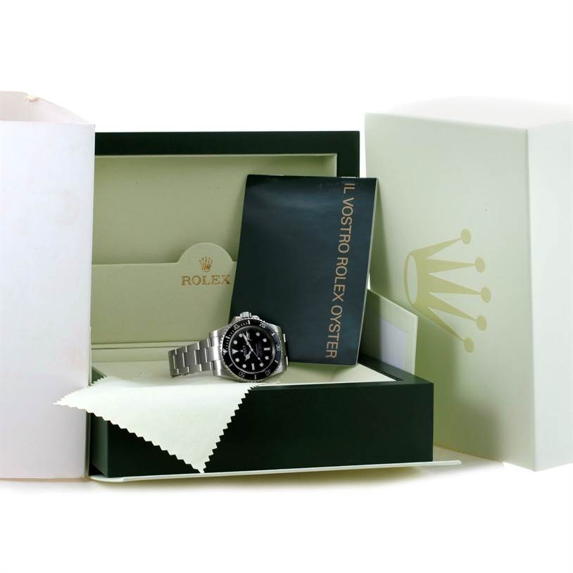 The image shows a Rolex Submariner 116610 Men
s Stainless Steel Black Dial 116610 Men
s Stainless Steel Black Dial watch displayed in its open box with accompanying accessories, including a booklet and cloth.