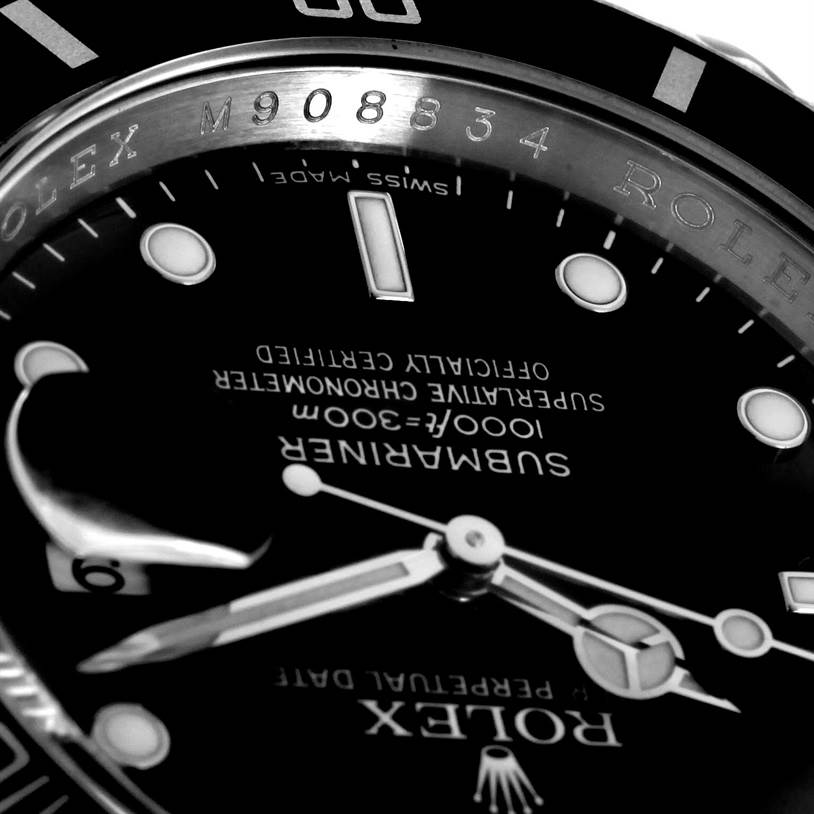 This close-up of the Rolex Submariner 16610 Men
s Stainless Steel Black Dial 16610 Men
s Stainless Steel Black Dial watch shows parts of the dial, hands, and serial number engraving on the bezel ring.