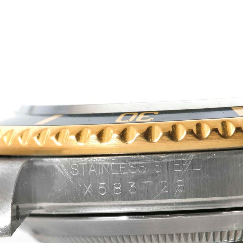 The image shows a close-up side view of the bezel and case of a Rolex Submariner 16613 Men's Steel and Gold (two tone) Black Dial 16613 Men's Steel and Gold (two tone) Black Dial, highlighting the stainless steel and gold elements.