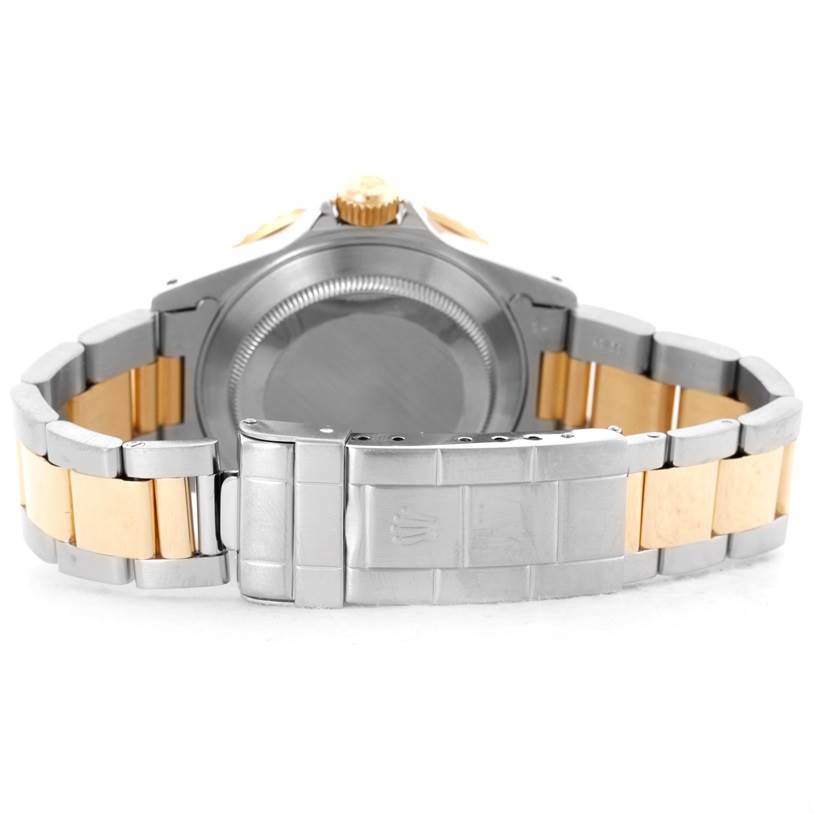 The image shows the back and clasp of a Rolex Submariner 16613 Men's Steel and Gold (two tone) Black Dial 16613 Men's Steel and Gold (two tone) Black Dial watch, highlighting the two-tone metal bracelet.