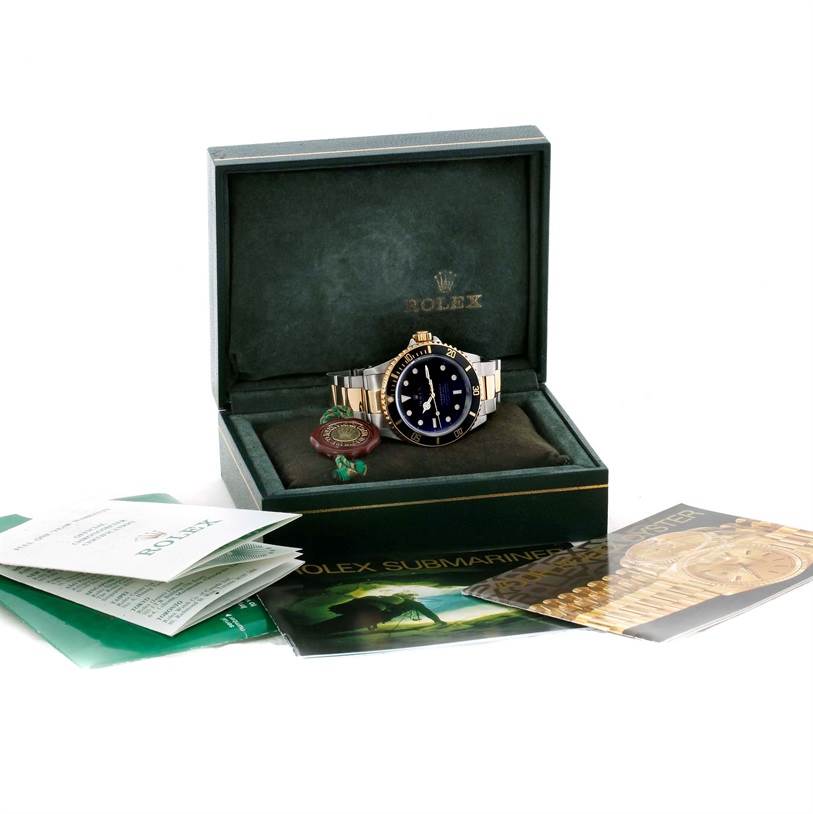 The image shows a Rolex Submariner 16613 Men's Steel and Gold (two tone) Black Dial 16613 Men's Steel and Gold (two tone) Black Dial watch in its open box alongside various documents and tags.