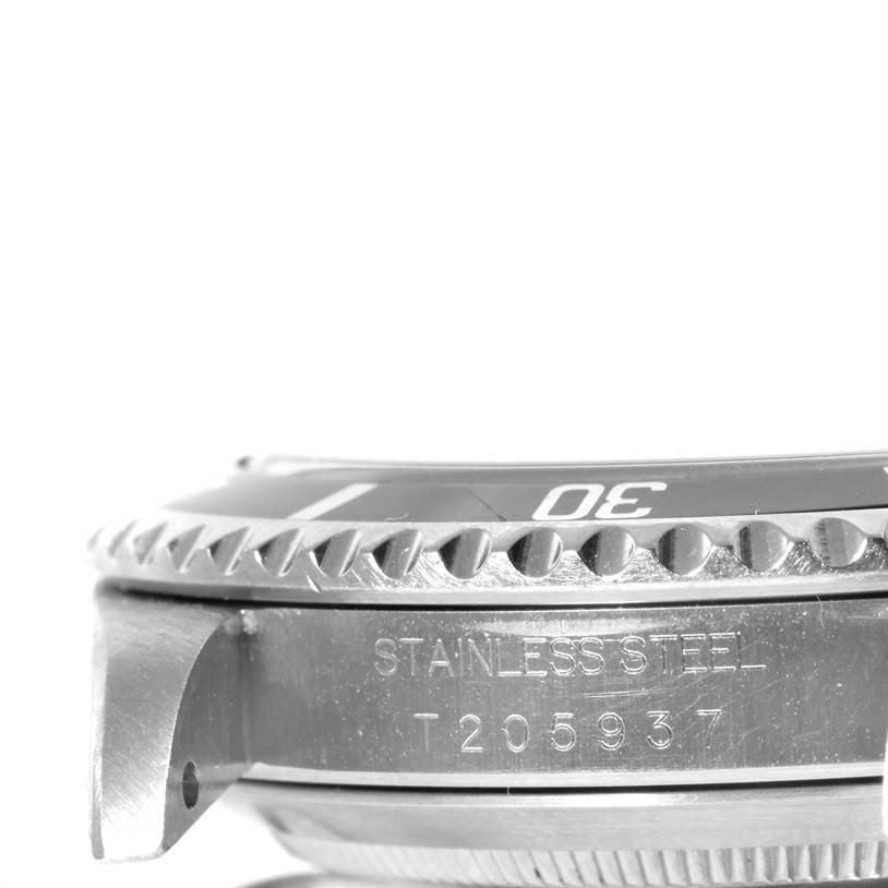 This image shows the side profile and part of the bezel of a Rolex Submariner 14060 Men
s Stainless Steel Black Dial 14060 Men
s Stainless Steel Black Dial watch, highlighting the stainless steel material and serial number.