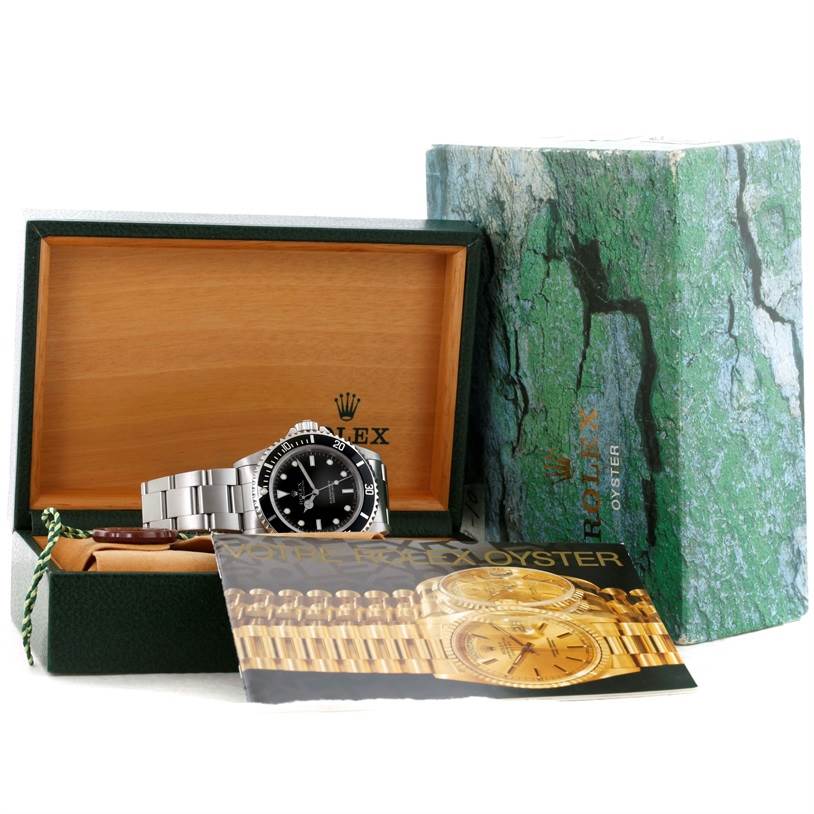 This image shows a Rolex Submariner 14060 Men
s Black Dial 14060 Men
s Black Dial watch, its box, outer packaging, and accompanying booklet from a front angle.