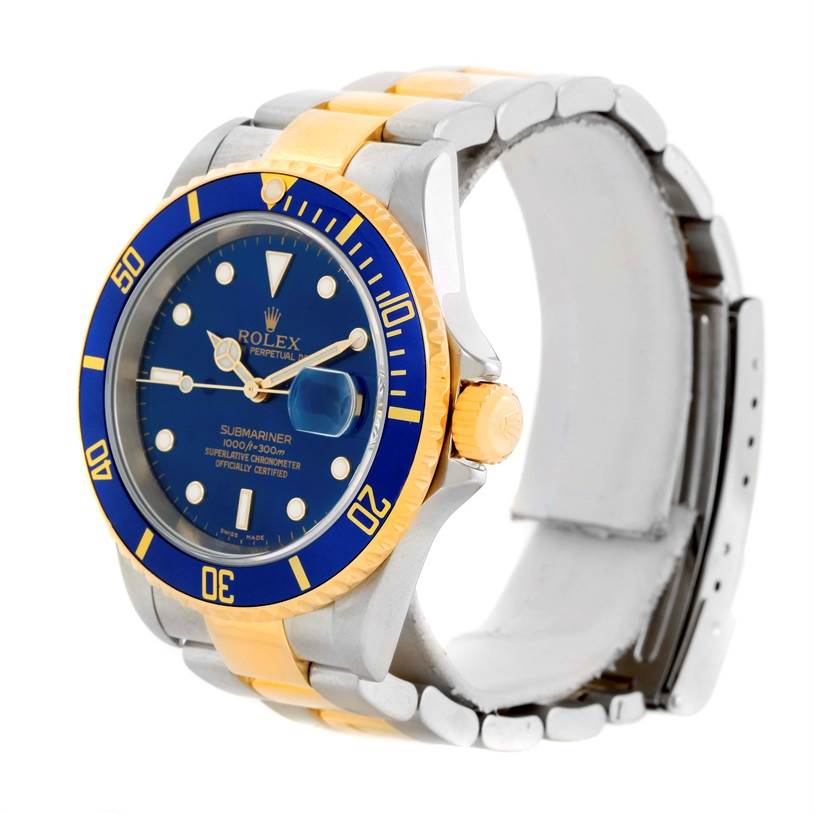 The image shows a Rolex Submariner 16613 Men
s Steel and Gold (two tone) Blue Dial 16613 Men
s Steel and Gold (two tone) Blue Dial watch from a front-left angle, highlighting its blue dial, bezel, and two-tone bracelet.