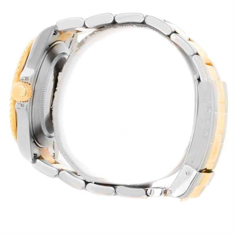 The image shows a side view of a Rolex Submariner 16613 Men
s Steel and Gold (two tone) Blue Dial 16613 Men
s Steel and Gold (two tone) Blue Dial watch, focusing on the crown, case, and part of the bracelet.