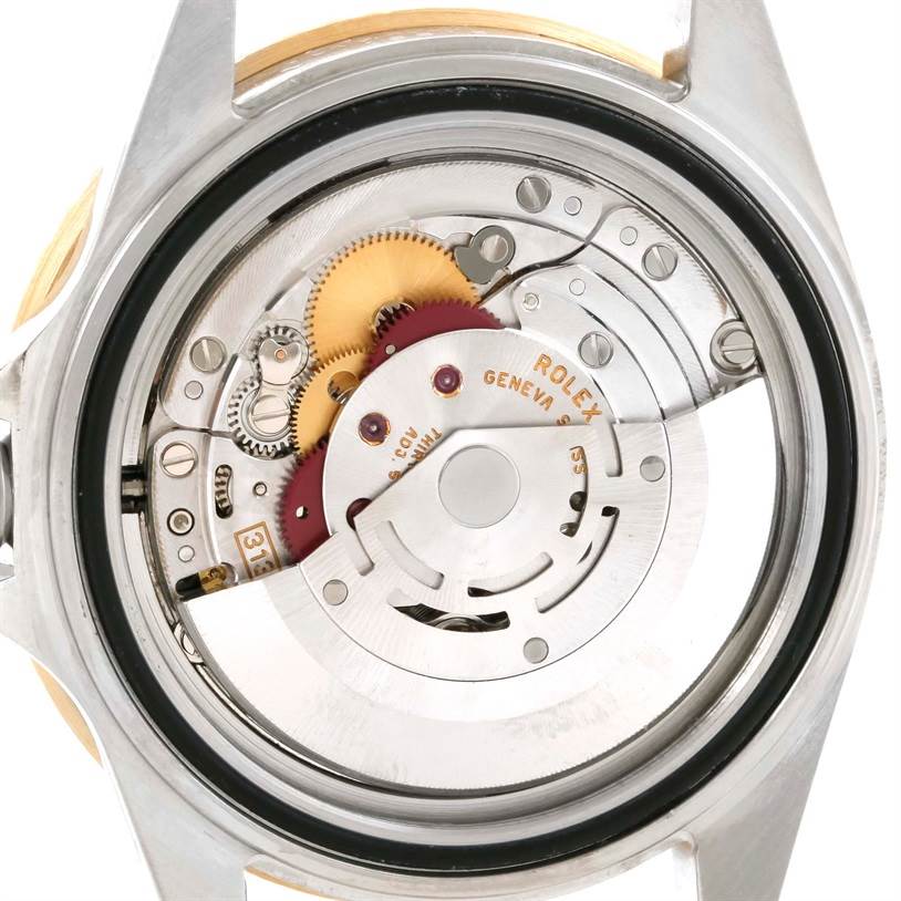 The image shows the intricate internal movement mechanism of a Rolex Submariner 16613 Men
s Steel and Gold (two tone) Blue Dial 16613 Men
s Steel and Gold (two tone) Blue Dial watch from the back angle.