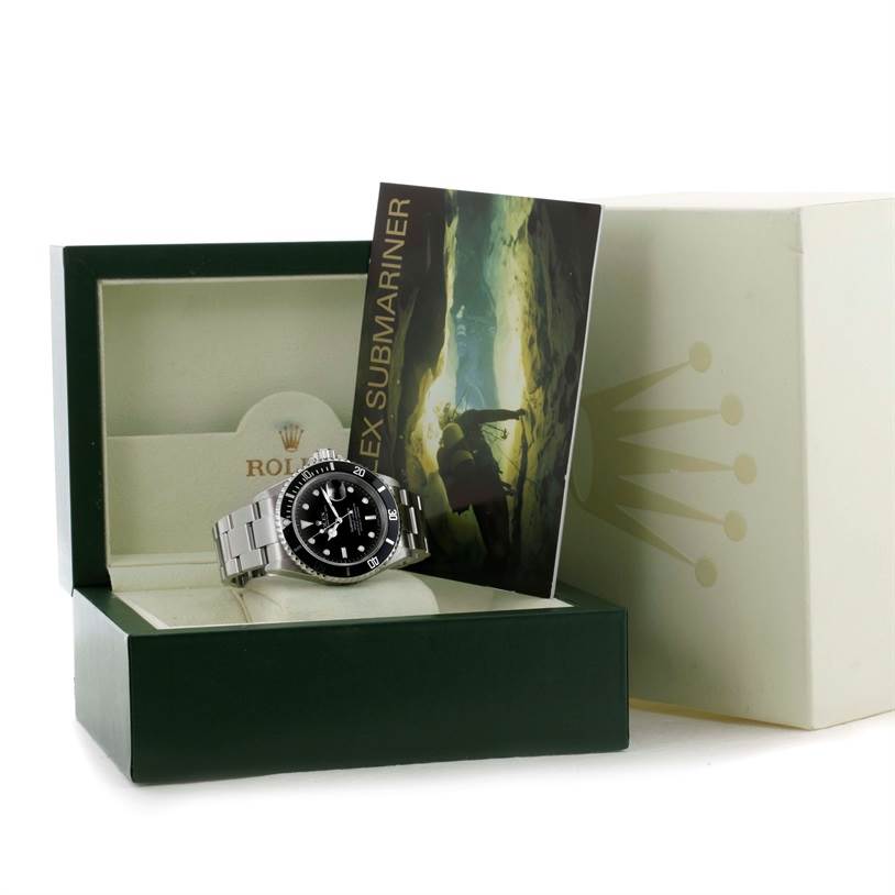 The image shows a Rolex Submariner 16610 Men's Stainless Steel Black Dial 16610 Men's Stainless Steel Black Dial watch inside its open box, accompanied by a brochure.