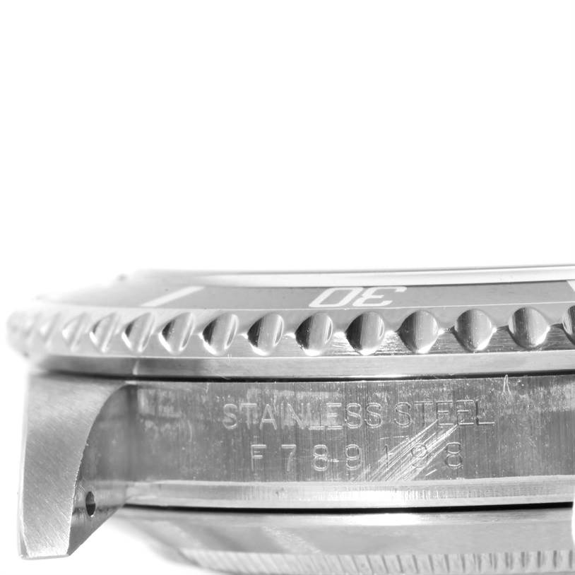 The image shows a side view of the Rolex Submariner 16610 Men's Stainless Steel Black Dial 16610 Men's Stainless Steel Black Dial watch, focusing on its bezel and engraved stainless steel side.