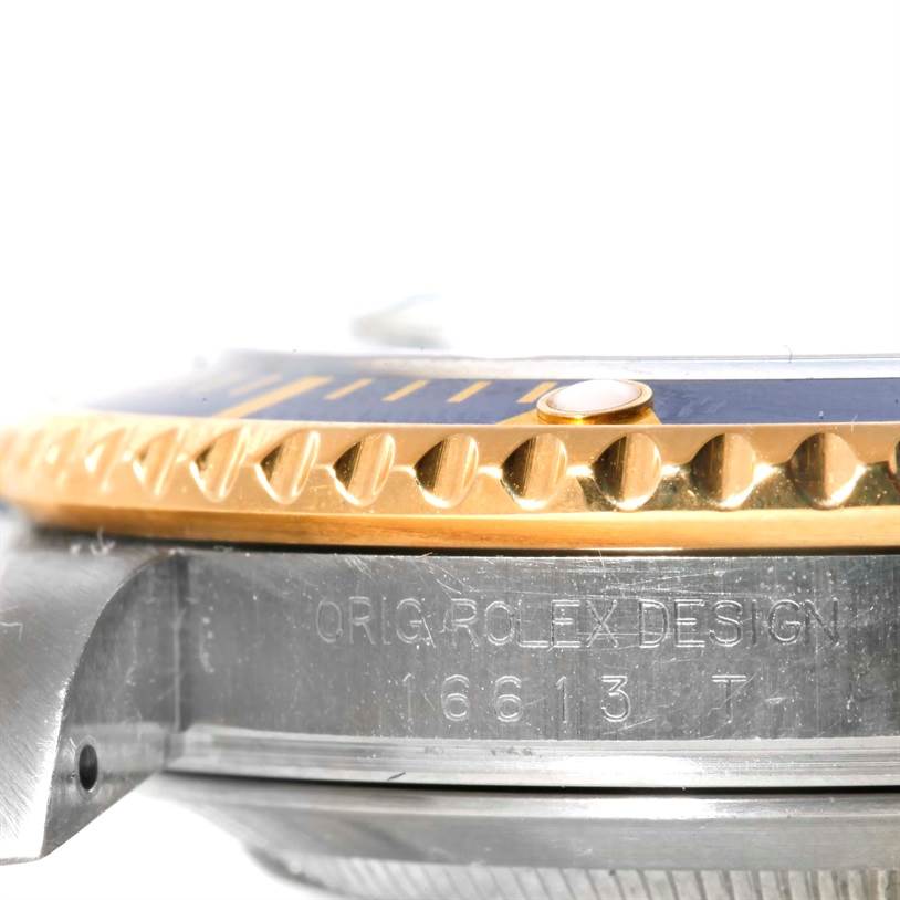 This image shows a close-up side view focusing on the bezel and case of a Rolex Submariner 16613 Men
s Steel and Gold (two tone) Blue Dial 16613 Men
s Steel and Gold (two tone) Blue Dial watch.