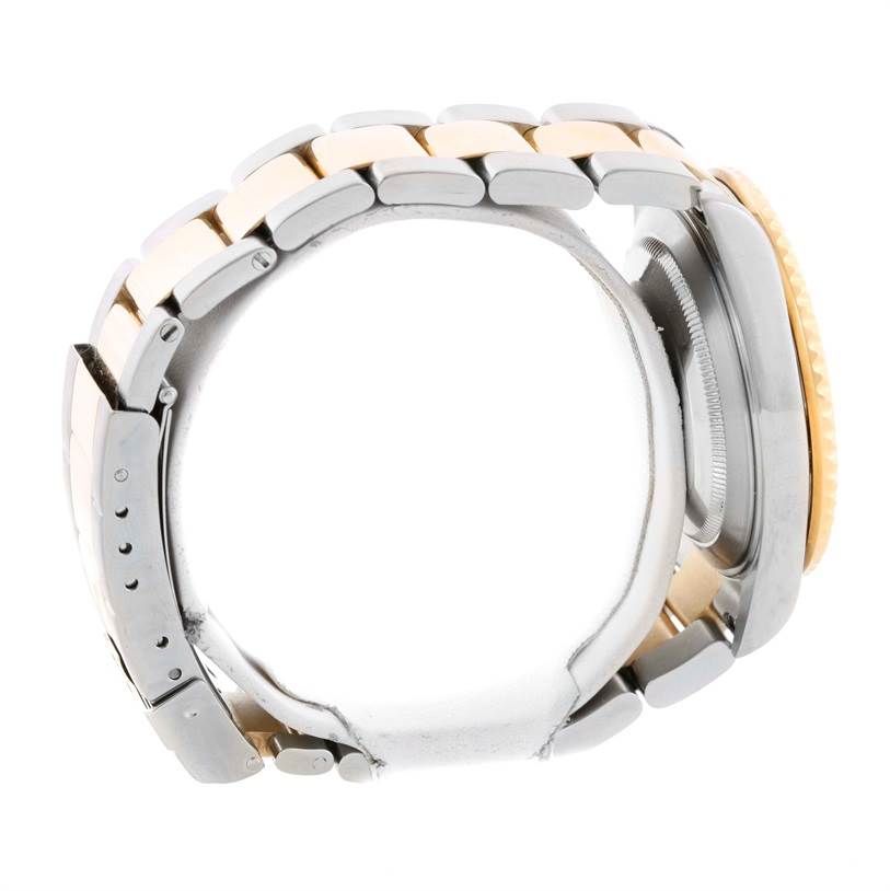 The image shows the side profile of a Rolex Submariner 16613 Men
s Steel and Gold (two tone) Blue Dial 16613 Men
s Steel and Gold (two tone) Blue Dial, focusing on the case, bezel, and bracelet links.