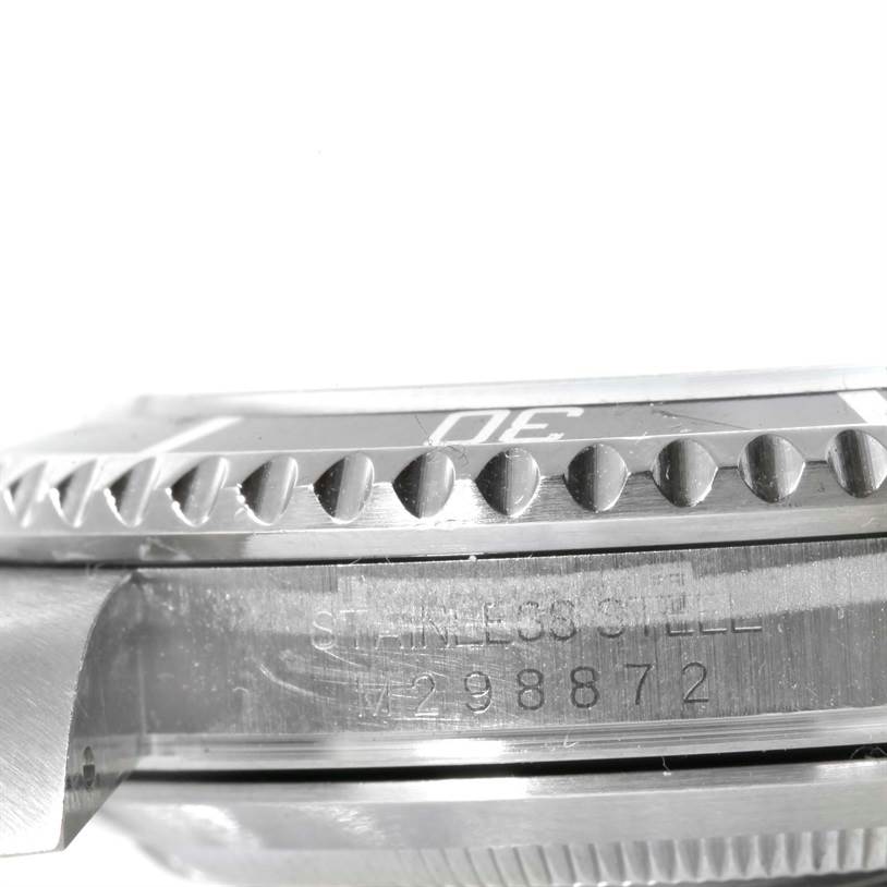 This image shows a close-up side view of the bezel and case of a Rolex Submariner 16610 Men
s Stainless Steel Black Dial 16610 Men
s Stainless Steel Black Dial watch with part of its serial number visible.