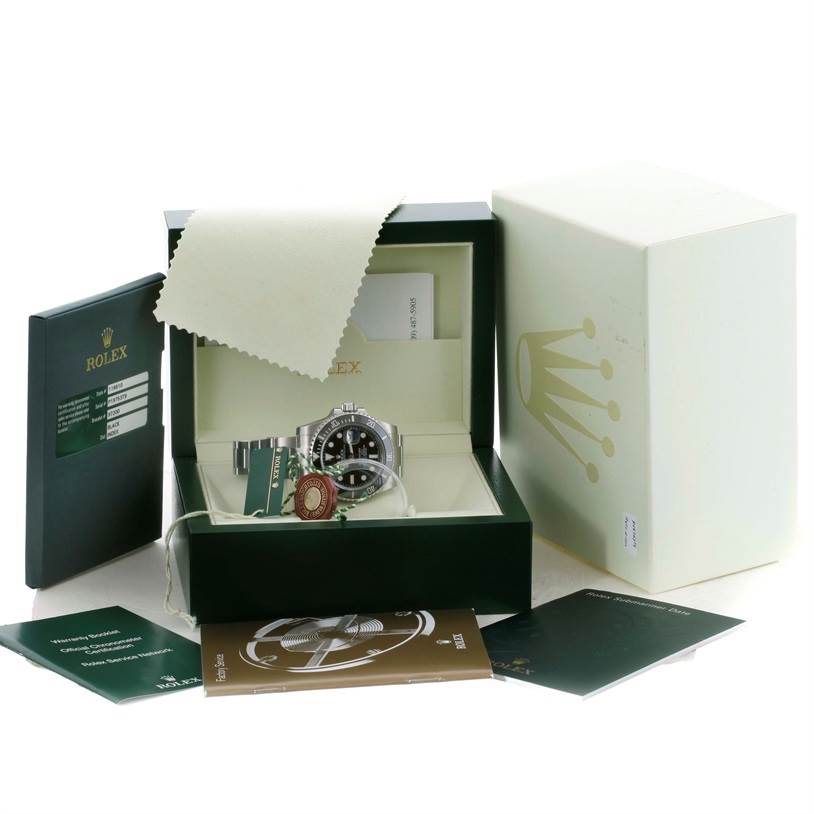 The image shows a Rolex Submariner 116610 Men
s Stainless Steel Black Dial 116610 Men
s Stainless Steel Black Dial watch from a front angle, along with its box, warranty cards, manuals, and tags.