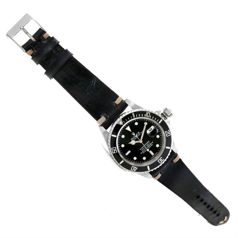 This image shows a Rolex Submariner 16610 Men
s Stainless Steel Black Dial 16610 Men
s Stainless Steel Black Dial watch laid flat with its full dial, bezel, and leather strap visible.