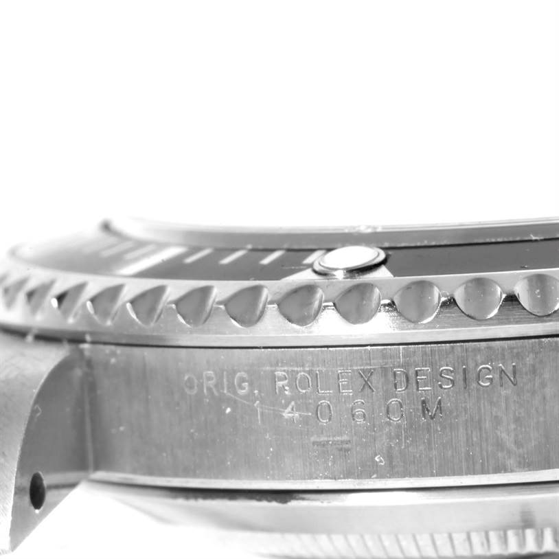 The image shows a close-up side view of a Rolex Submariner 14060 Men
s Stainless Steel Black Dial 14060 Men
s Stainless Steel Black Dial watch, highlighting the bezel and case with engraved details.