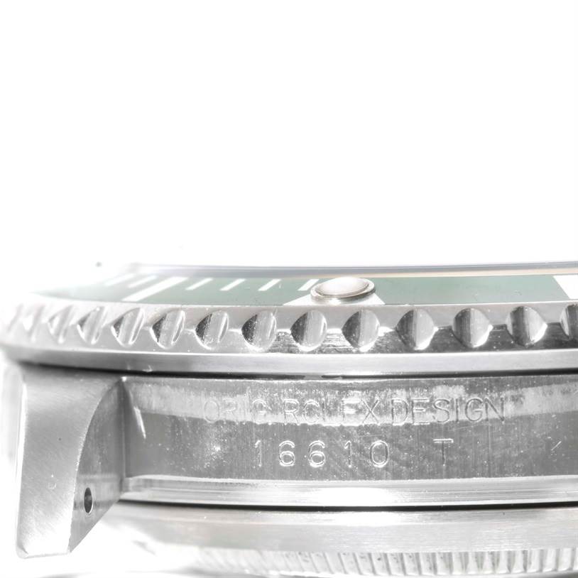 The image shows a close-up, side view of the bezel and case of a Rolex Submariner 16610LV Men
s Stainless Steel Black Dial 16610LV Men
s Stainless Steel Black Dial model watch, including part of the reference number.