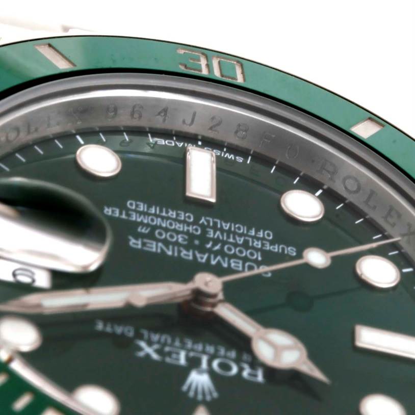 Close-up of a Rolex Submariner 116610LV Men's Stainless Steel Green Dial 116610LV Men's Stainless Steel Green Dial watch face, highlighting the green bezel and partially visible hour markers and hands.