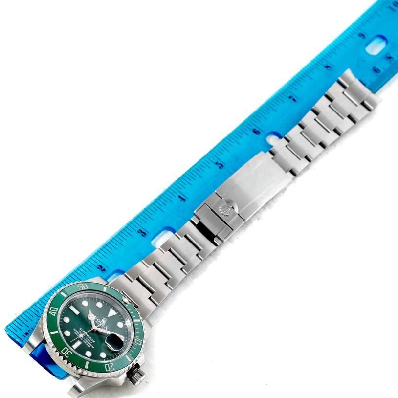This image shows a Rolex Submariner 116610LV Men's Stainless Steel Green Dial 116610LV Men's Stainless Steel Green Dial watch with a green bezel, measured beside a blue ruler, showcasing the face and bracelet.