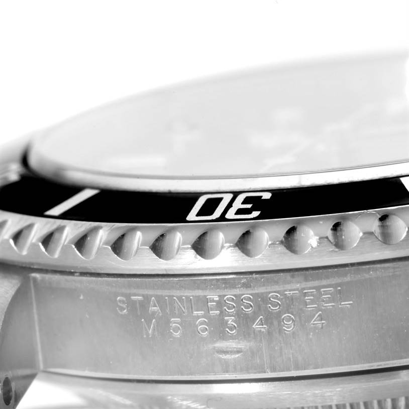 This close-up angle of the Rolex Submariner 14060 Men
s Stainless Steel Black Dial 14060 Men
s Stainless Steel Black Dial shows the stainless steel case, bezel with "30" marking, and a portion of the serial number.