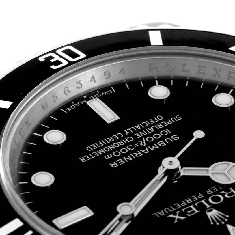 This close-up image of a Rolex Submariner 14060 Men
s Stainless Steel Black Dial 14060 Men
s Stainless Steel Black Dial watch shows part of the dial, hands, and the 30-minute mark on the bezel.