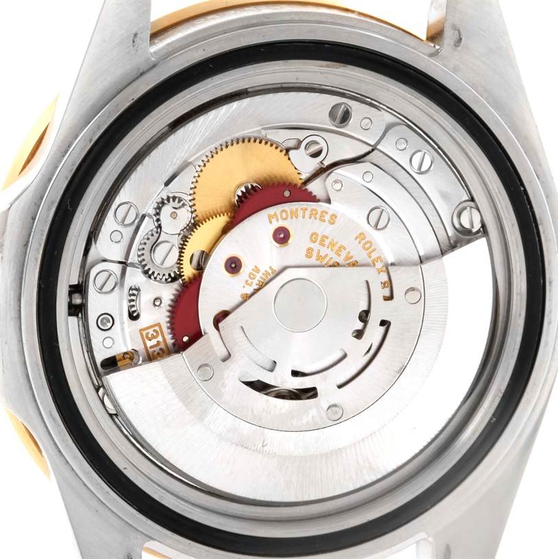 The image shows the back view of a Rolex Submariner 16613 Men
s Steel and Gold (two tone) Blue Dial 16613 Men
s Steel and Gold (two tone) Blue Dial watch, highlighting its intricate movement and internal components.