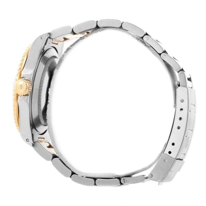 The image shows a side view of a Rolex Submariner 16613 Men
s Steel and Gold (two tone) Blue Dial 16613 Men
s Steel and Gold (two tone) Blue Dial watch, highlighting its bracelet, crown, and case.