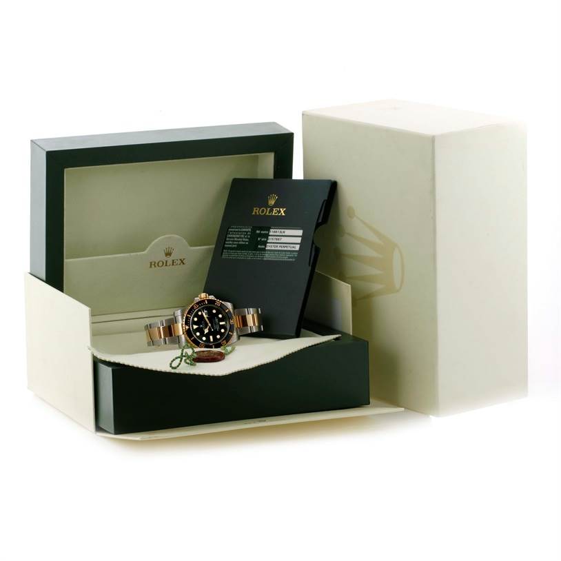 The Rolex Submariner 116613 Men
s Steel and Gold (two tone) Black Dial 116613 Men
s Steel and Gold (two tone) Black Dial watch is shown at an angle in its box alongside accessories and documentation.