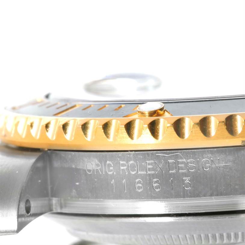 The image shows the side view of a Rolex Submariner 116613 Men
s Steel and Gold (two tone) Black Dial 116613 Men
s Steel and Gold (two tone) Black Dial, highlighting the bezel and part of the case with engravings.