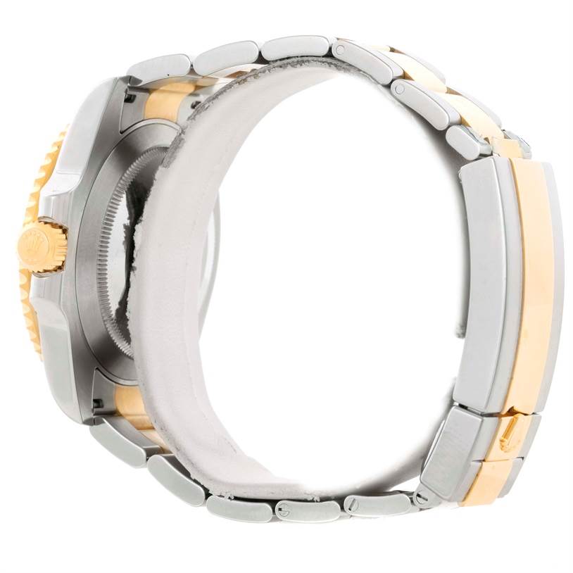 This Rolex Submariner 116613 Men
s Steel and Gold (two tone) Black Dial 116613 Men
s Steel and Gold (two tone) Black Dial watch is shown from the side, highlighting the crown and the two-tone bracelet.