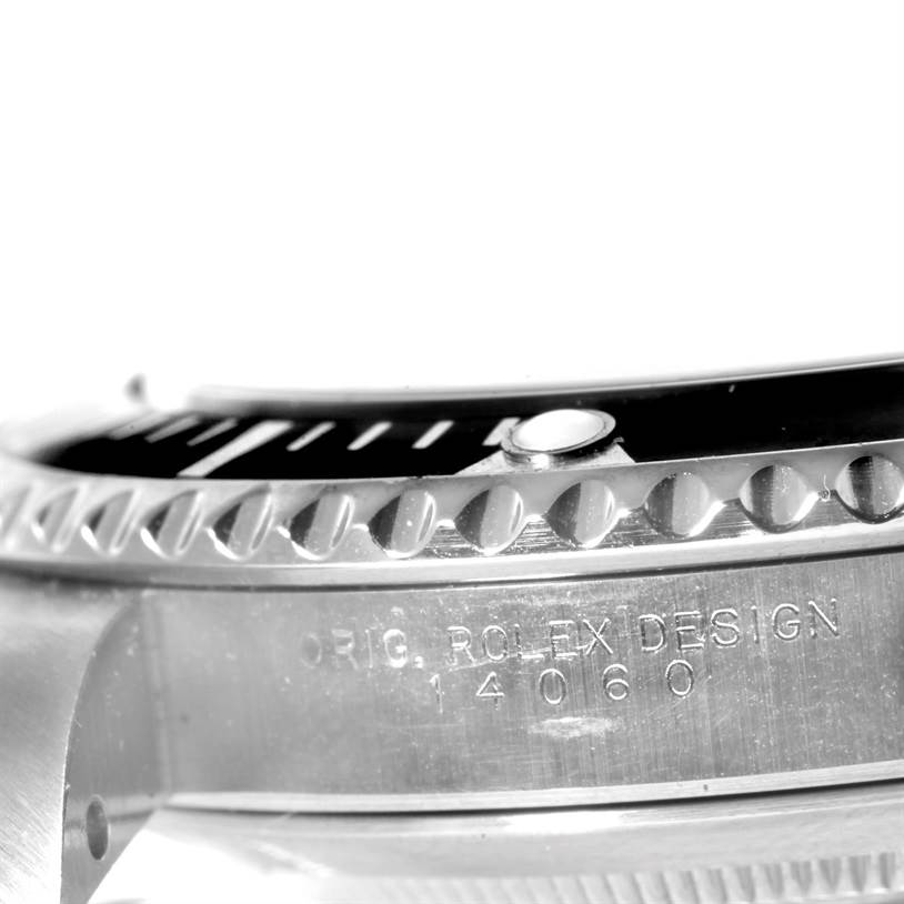 The image shows a close-up view of the side and the bezel of a Rolex Submariner 14060 Men
s Stainless Steel Black Dial 14060 Men
s Stainless Steel Black Dial watch, revealing the engraved model number.