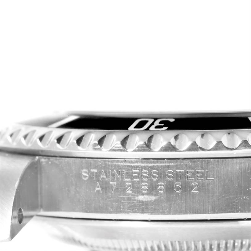 The image shows a close-up side view of the bezel and case of a Rolex Submariner 14060 Men
s Stainless Steel Black Dial 14060 Men
s Stainless Steel Black Dial, highlighting the model number and "Stainless Steel" engraving.