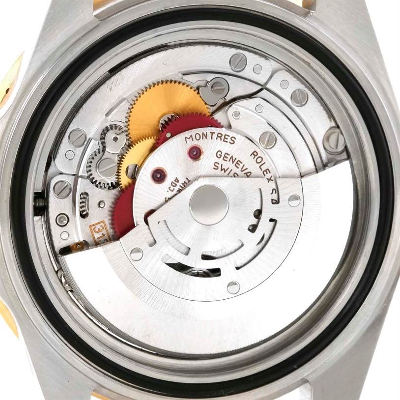 This image shows the movement mechanism of a Rolex Submariner 16613 Men's Steel and Gold (two tone) Champagne Dial 16613 Men's Steel and Gold (two tone) Champagne Dial, highlighting gears and inscriptions from the case back removed.