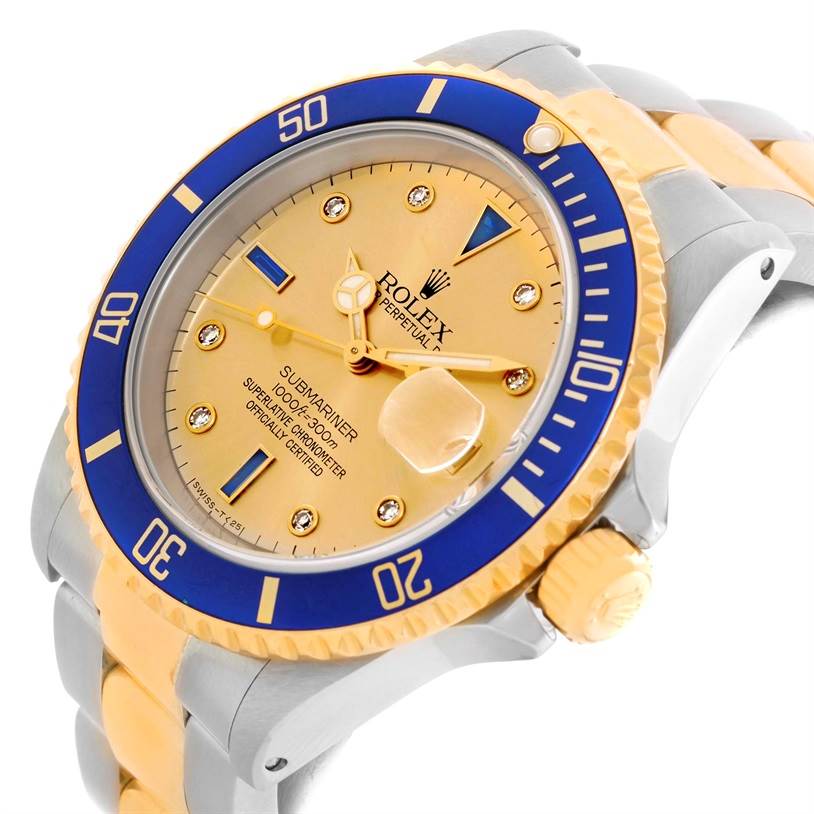 The image shows a tilted angle of the Rolex Submariner 16613 Men's Steel and Gold (two tone) Champagne Dial 16613 Men's Steel and Gold (two tone) Champagne Dial watch, highlighting its blue bezel, gold dial, and two-tone metal bracelet.