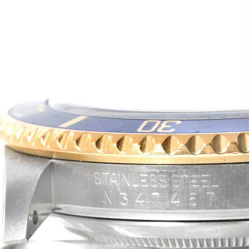 This image shows a close-up side angle of the bezel and mid-case of a Rolex Submariner 16613 Men's Steel and Gold (two tone) Champagne Dial 16613 Men's Steel and Gold (two tone) Champagne Dial watch.